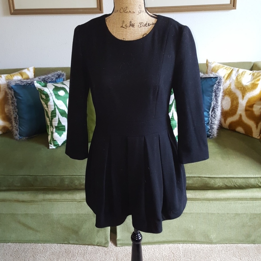 Sophisticated pleated black mini dress.